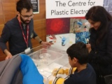 Child and mother taking part in science festival stand