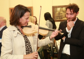Catherine West MP tries out the spider silk violin.