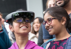 A young Festival attendee wears tech glasses