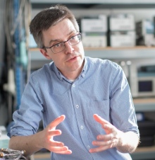 Professor Timothy Horbury sits in his office, explaining a concept to someone off-camera