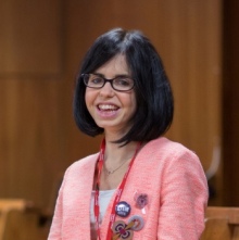 Dr Jessica Wade stands smiling in a lecture theatre