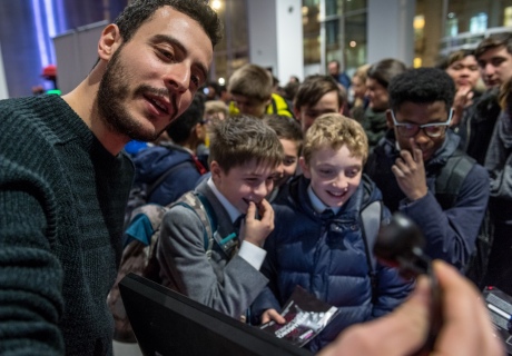 A researcher interacts with visiting schoolchildren