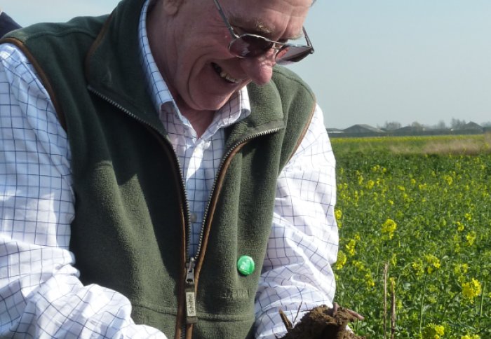 Farmer and Conservation Agriculture practitioner Tony Reynolds holds earth full of earthworms dug from his field