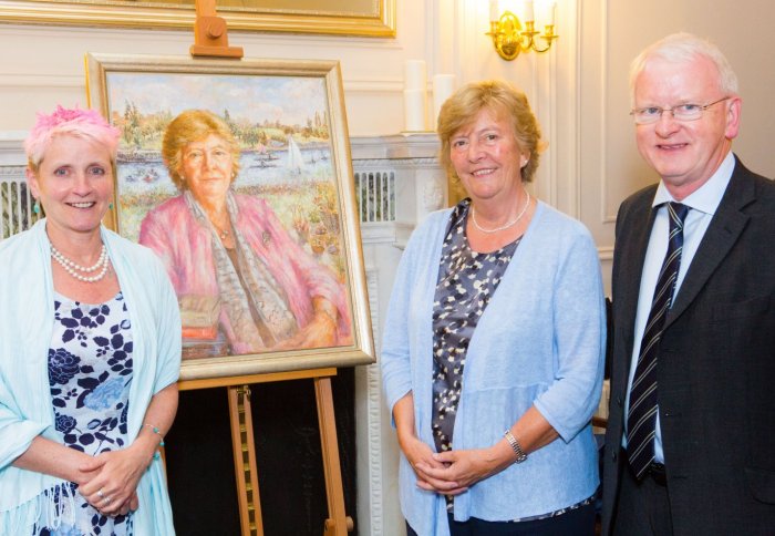 Professor Dame Julia Higgins and artist Tess Barnes stand in front of Julia's portrait