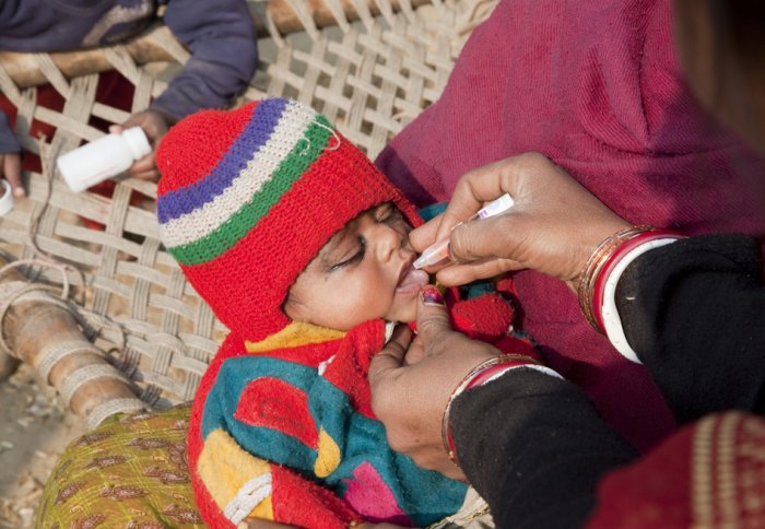 A child receives oral polio vaccine drops from a house-to-house polio vaccination team in Bihar, India. Photo: Gates Foundation/Flickr