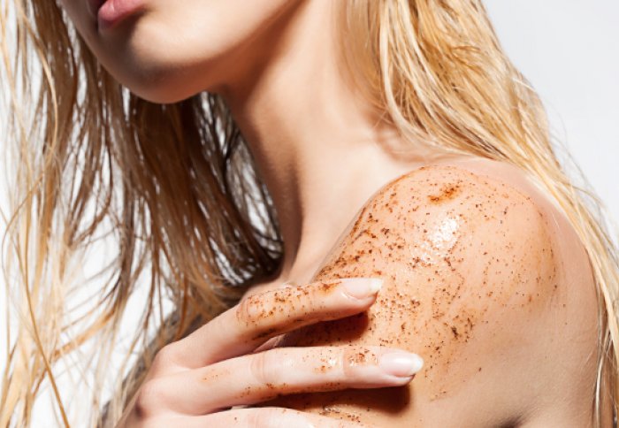 Woman using body scrub