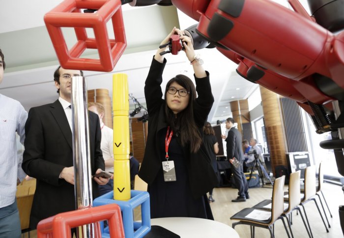 A delegate interacts with one of the exhibits