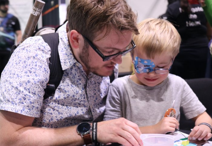 Father and son read instructions for science activity