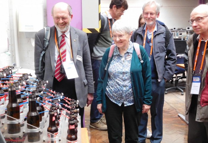 Alumni admiring our 'Bottle Organ' project in the lab