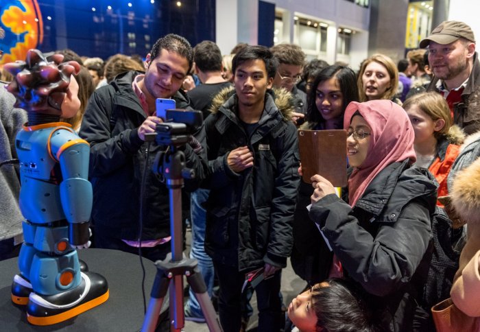 Visitors interact with humanoid robot Zeno