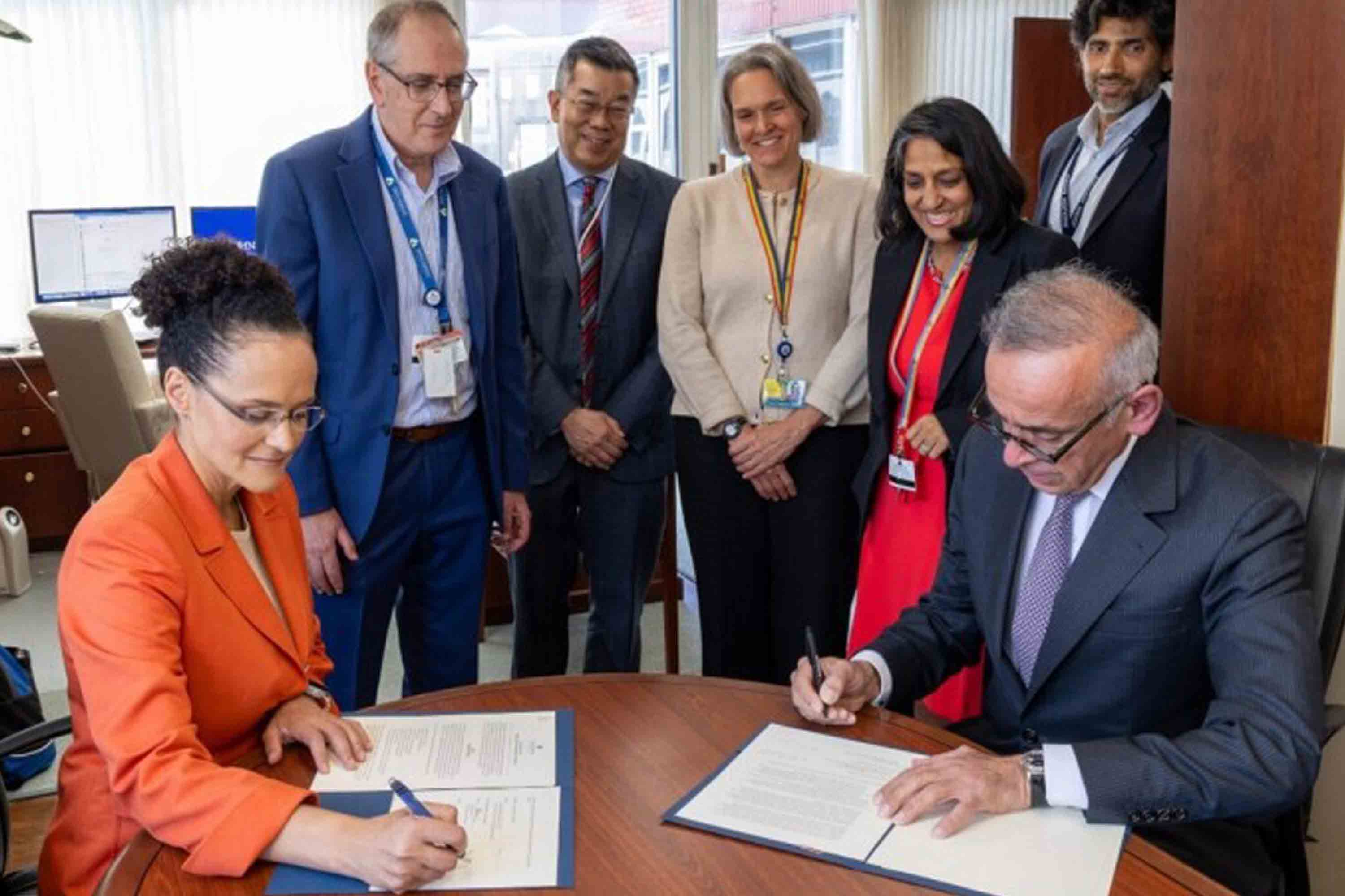 A photo of the Flemming Institute and John Hopkins University signing
