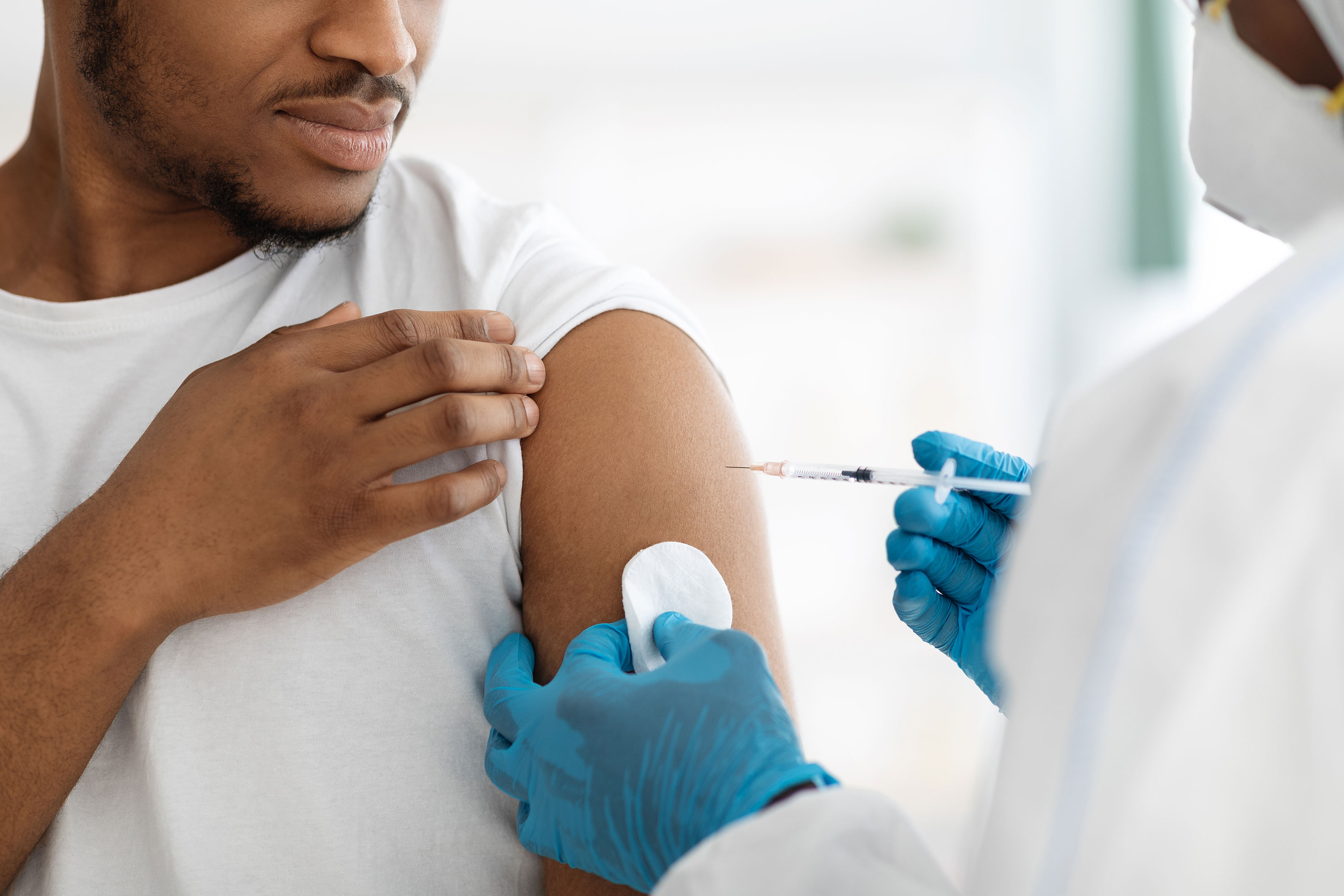 black man receiving vaccine shot