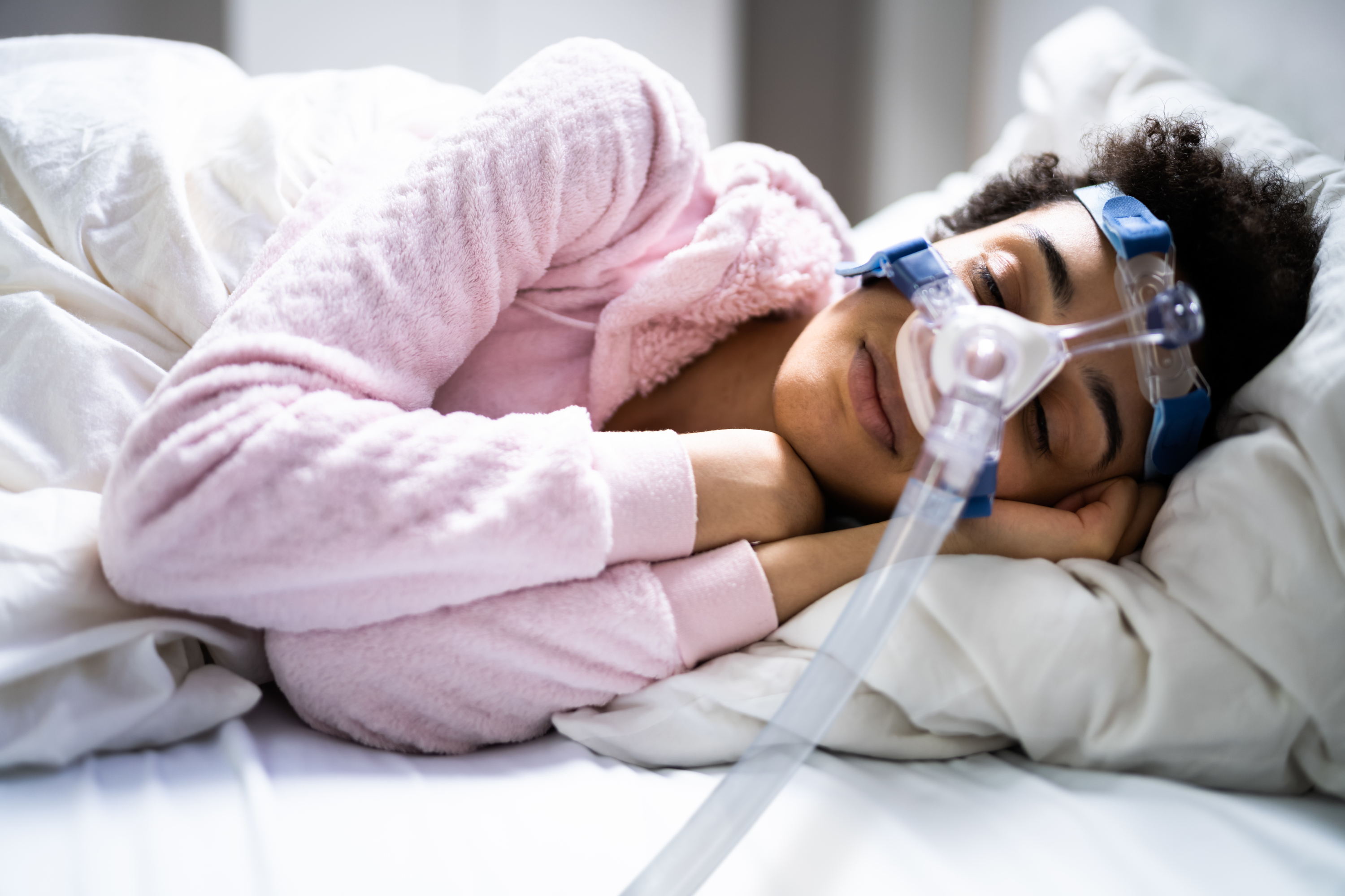 Sleeping woman with CPAP mask