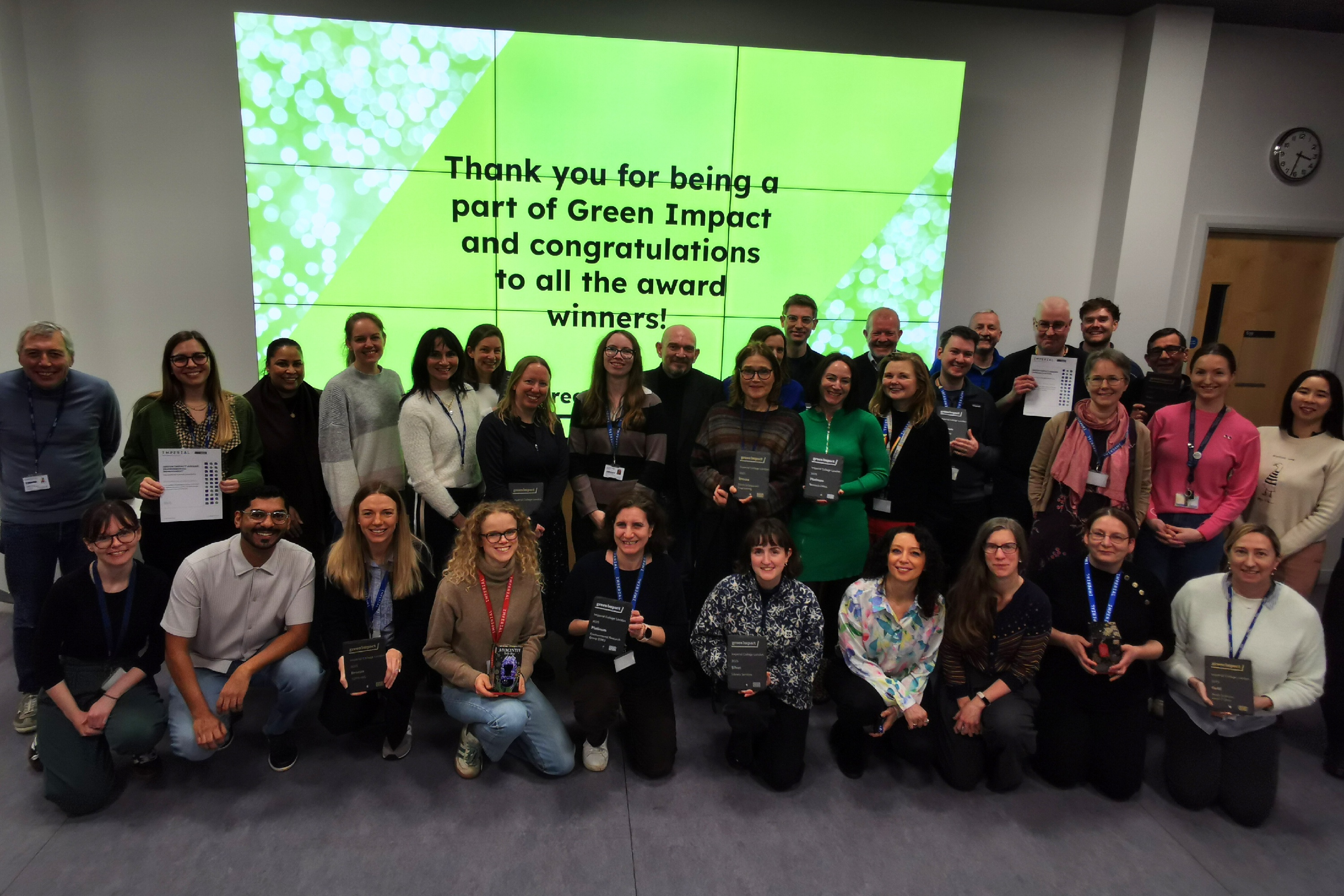 Staff members collecting their Green Impact award