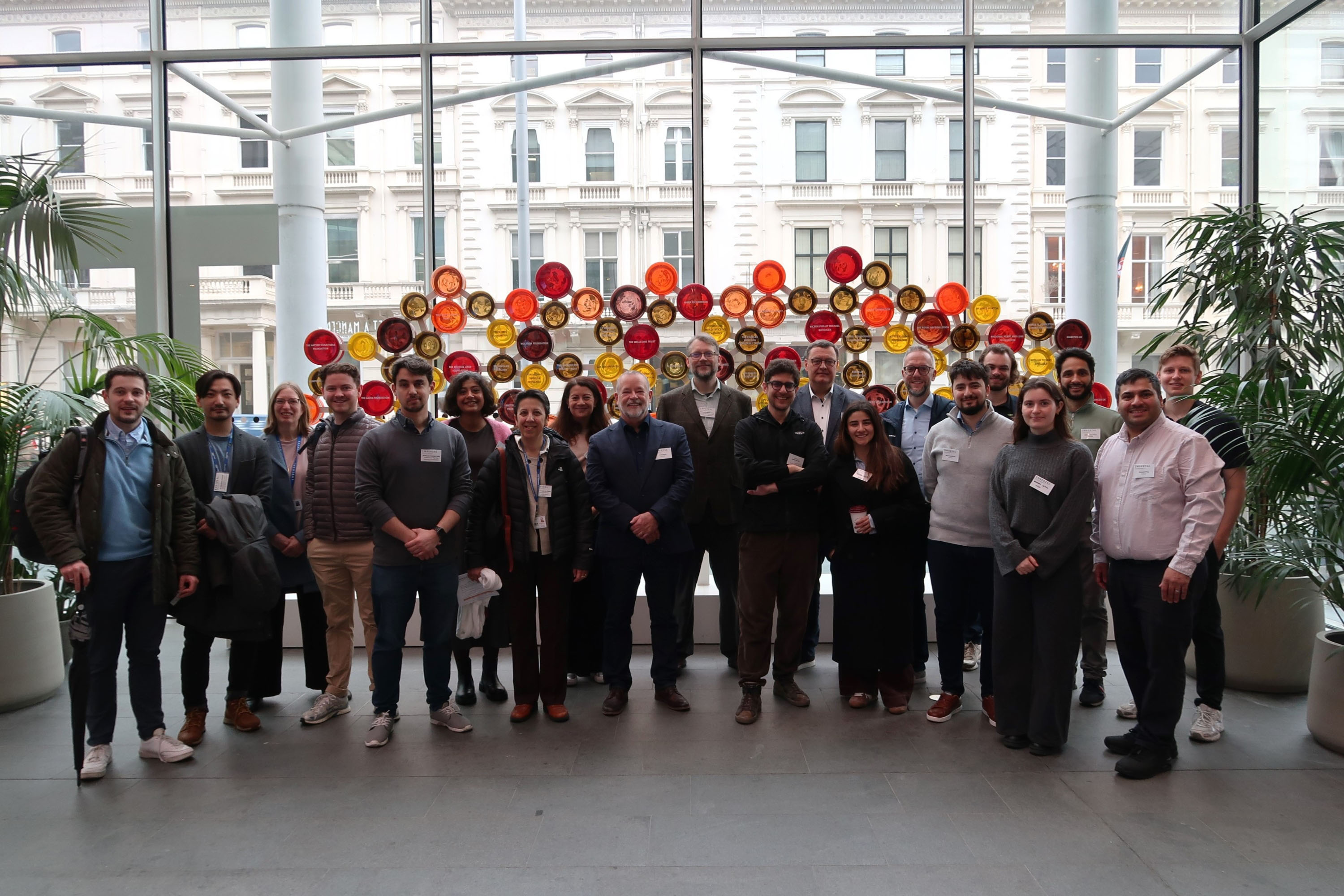 Group photo of NVIDIA Robotics delegates with School of Convergence Science academics in front of Circle of Benefactors artwork in the university main entrance