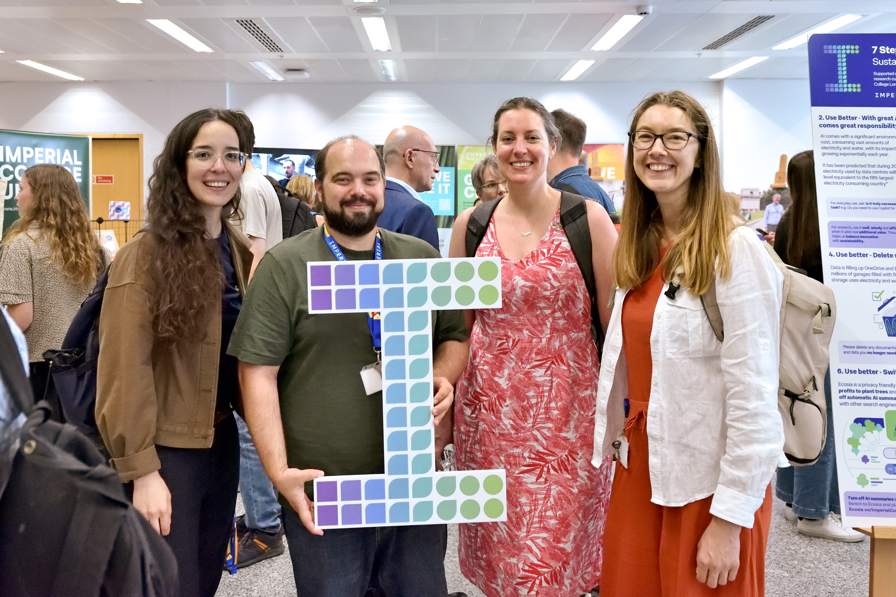 Attendees holding a large Sustainable I icon