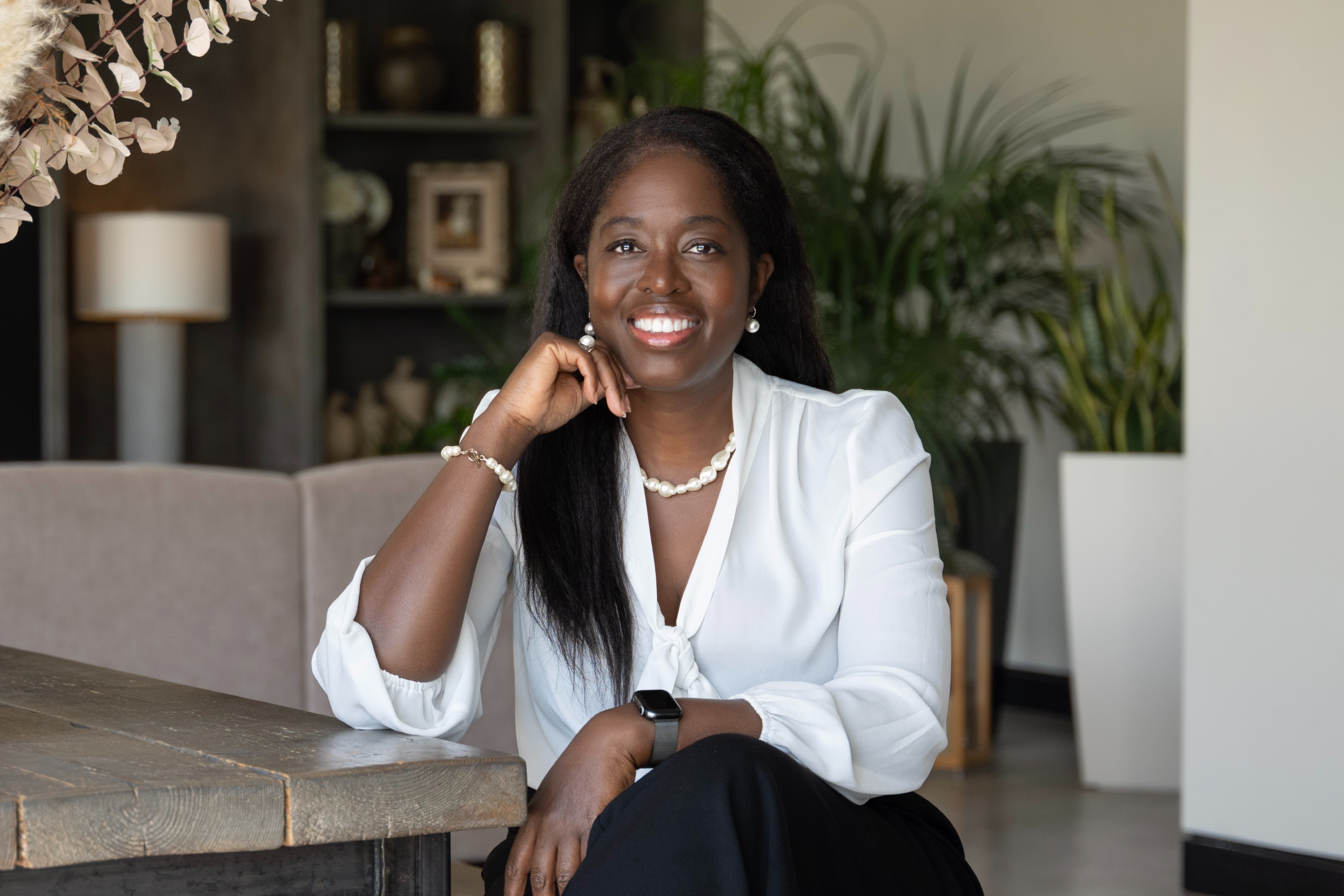 Dr Karen Joash sitting down and smiling for portrait shot