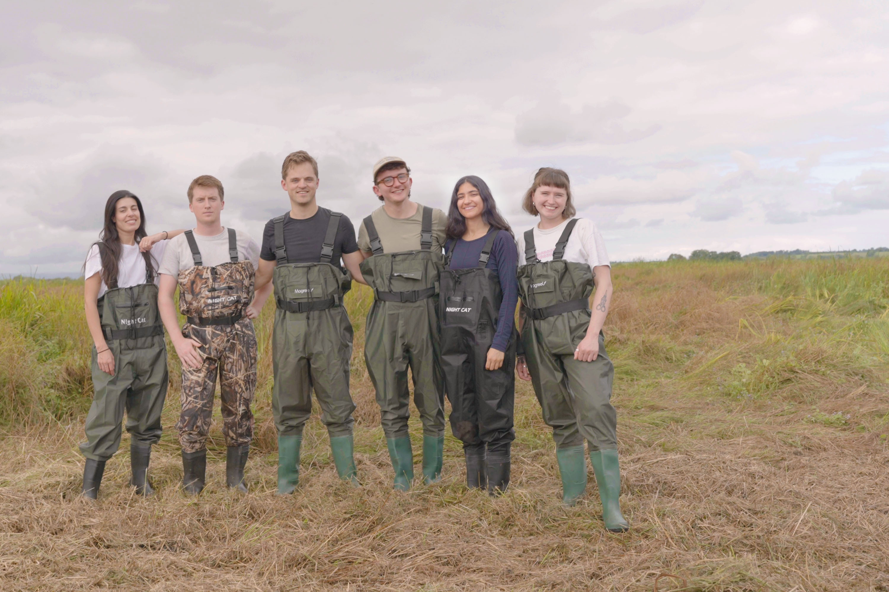 Ponda's team shown standing in a regenerated wetland environment