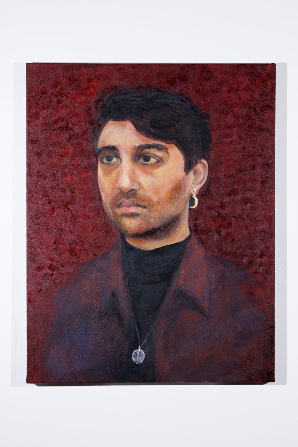 A picture of Tami Soji-Akinyemi's 'Kailash' - a portrait of Imperial staff member Kailash Ramlaul on a dark red background.