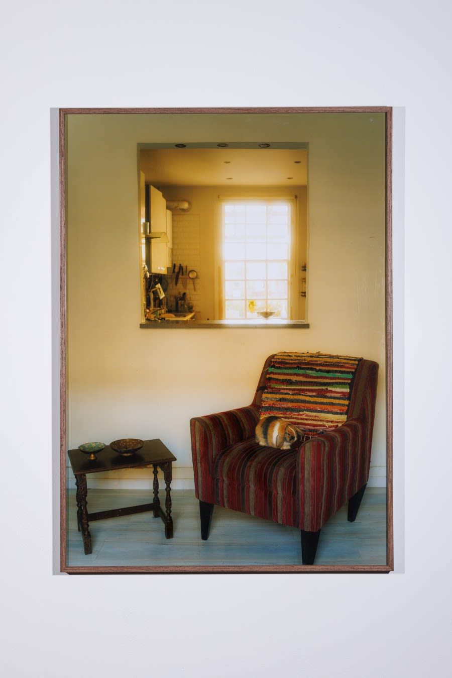 A picture of Sichan Wang's 'Who should sit here?' - a photograph that shows a rabbit sitting on an armchair next to a window and a small table.
