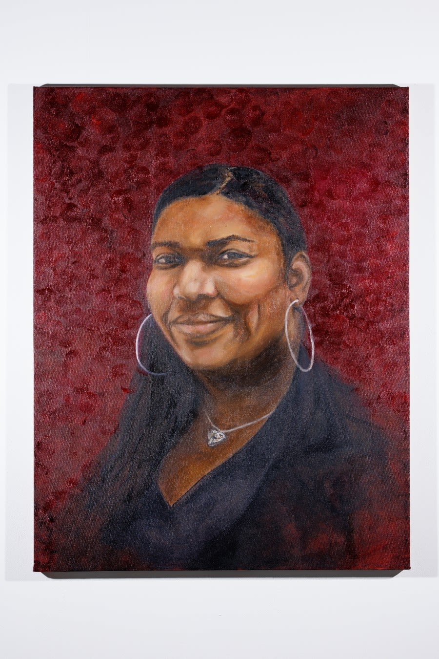 A picture of Tami Soji-Akinyemi's 'Gabriella' - a portrait of Imperial staff member Gabriella Gordon-Kerr on a dark red background.