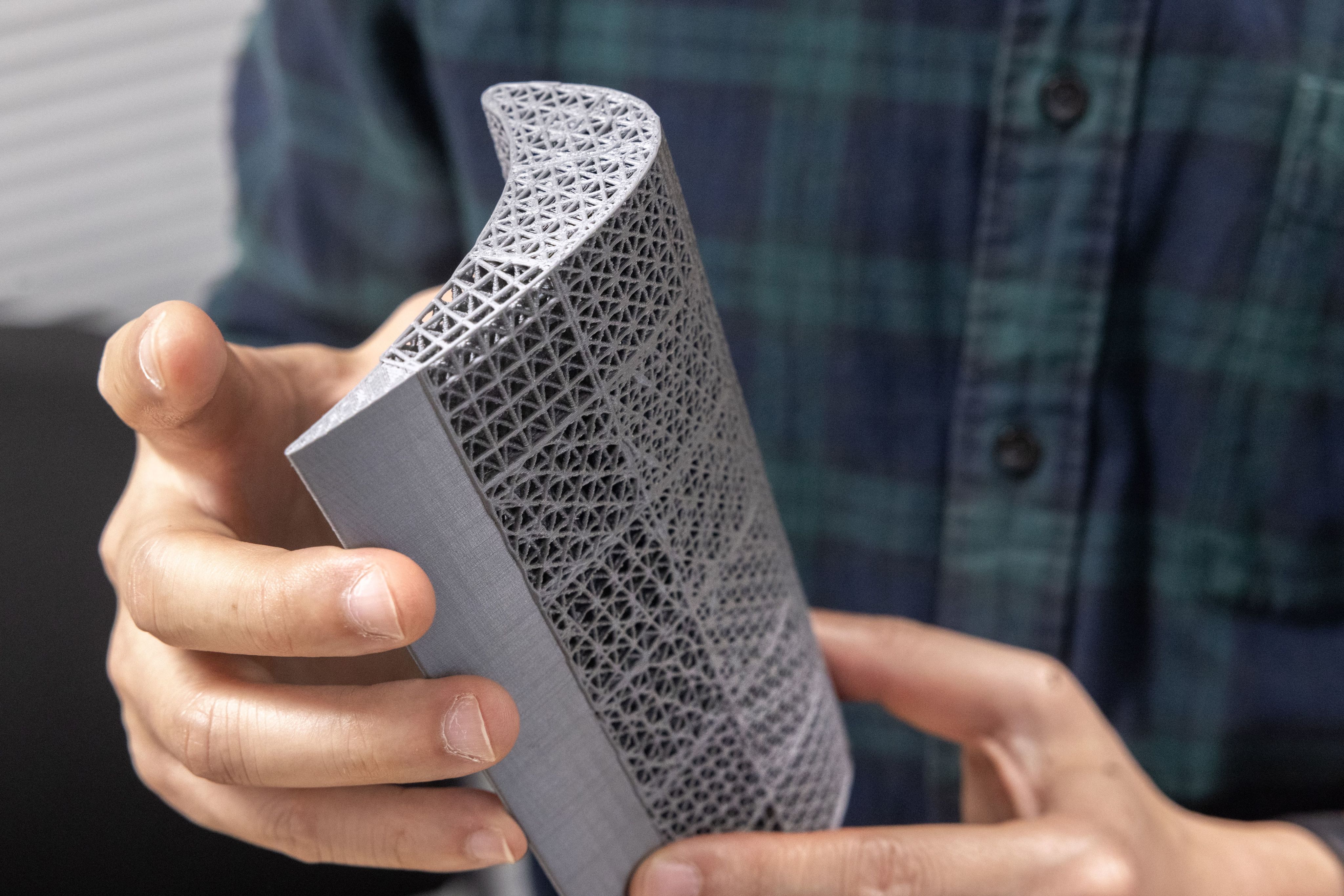 A complex 3D-printed model with a curved surface, featuring 15 distinct lattice structures.