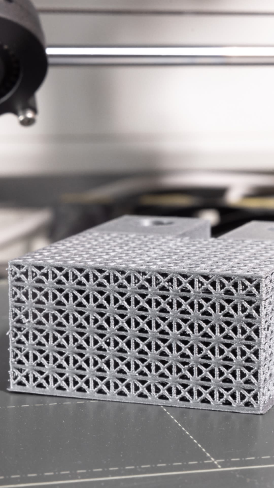 A rectangular 3D-printed model, featuring a lattice structure of small squares, each containing a cross.