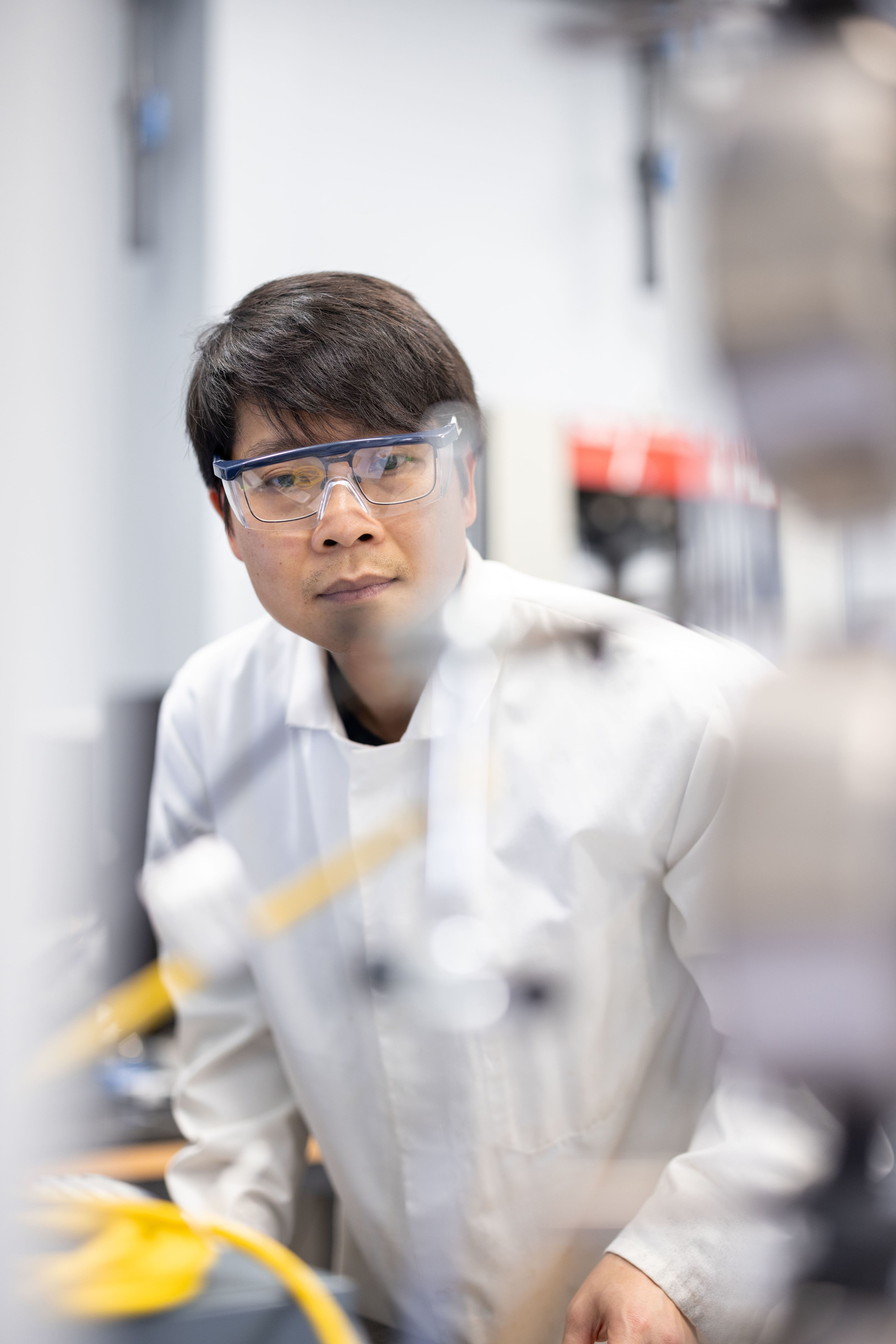 Dr Minh-Son Pham working in the laboratory, focused on his research.