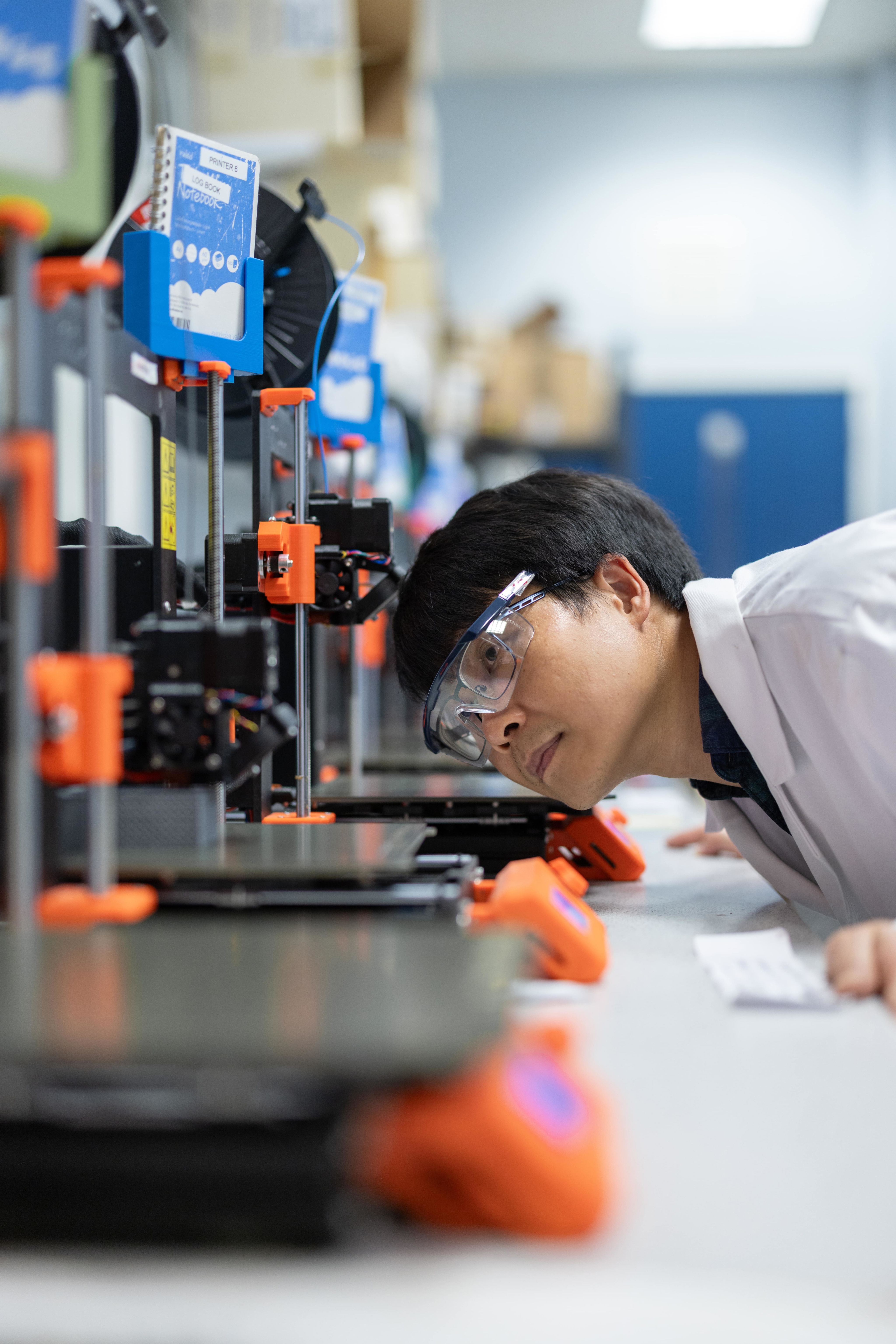 Dr Minh-Son Pham printing a new model on a 3D printer.