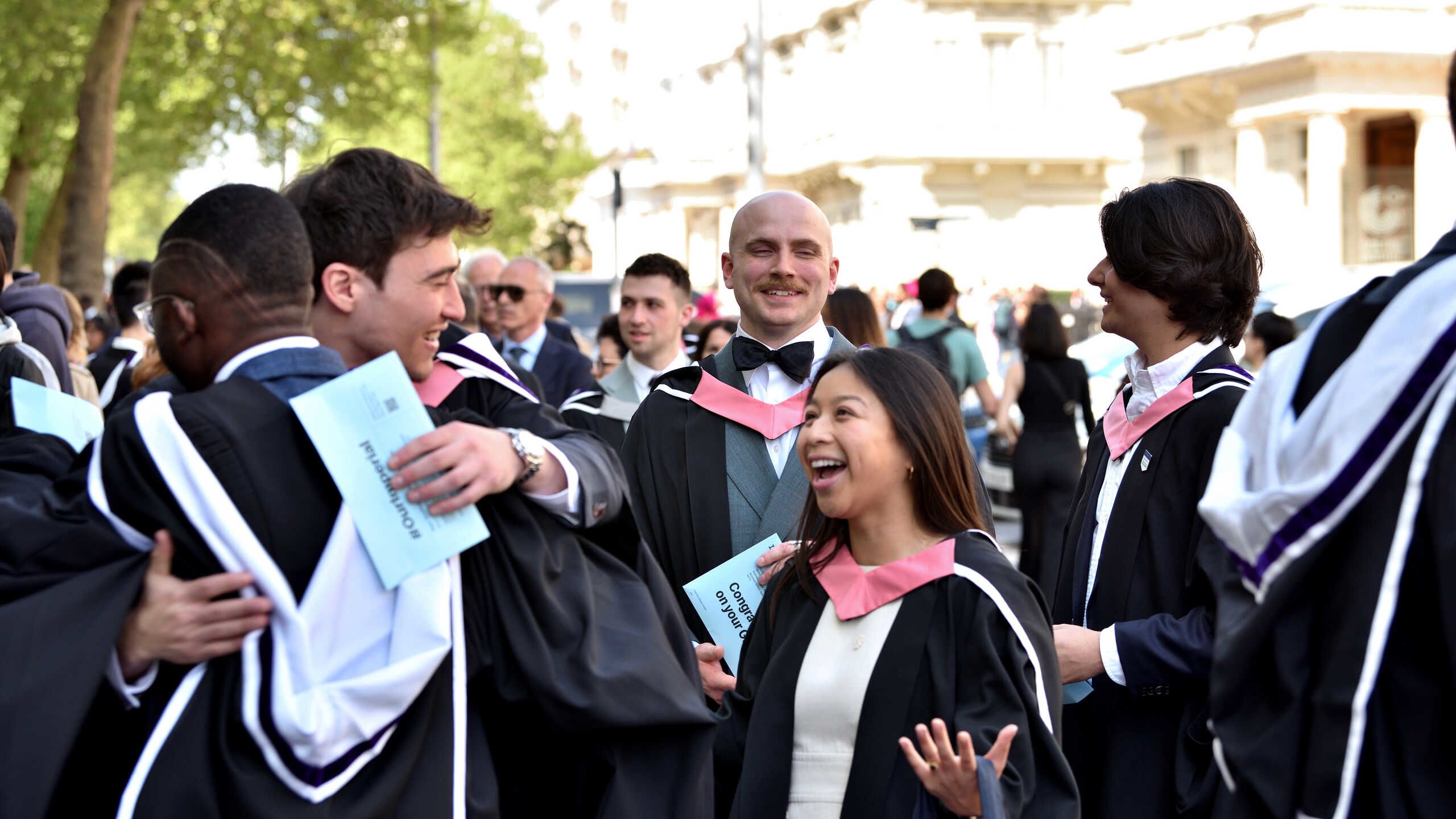 Imperial students hug at graduation