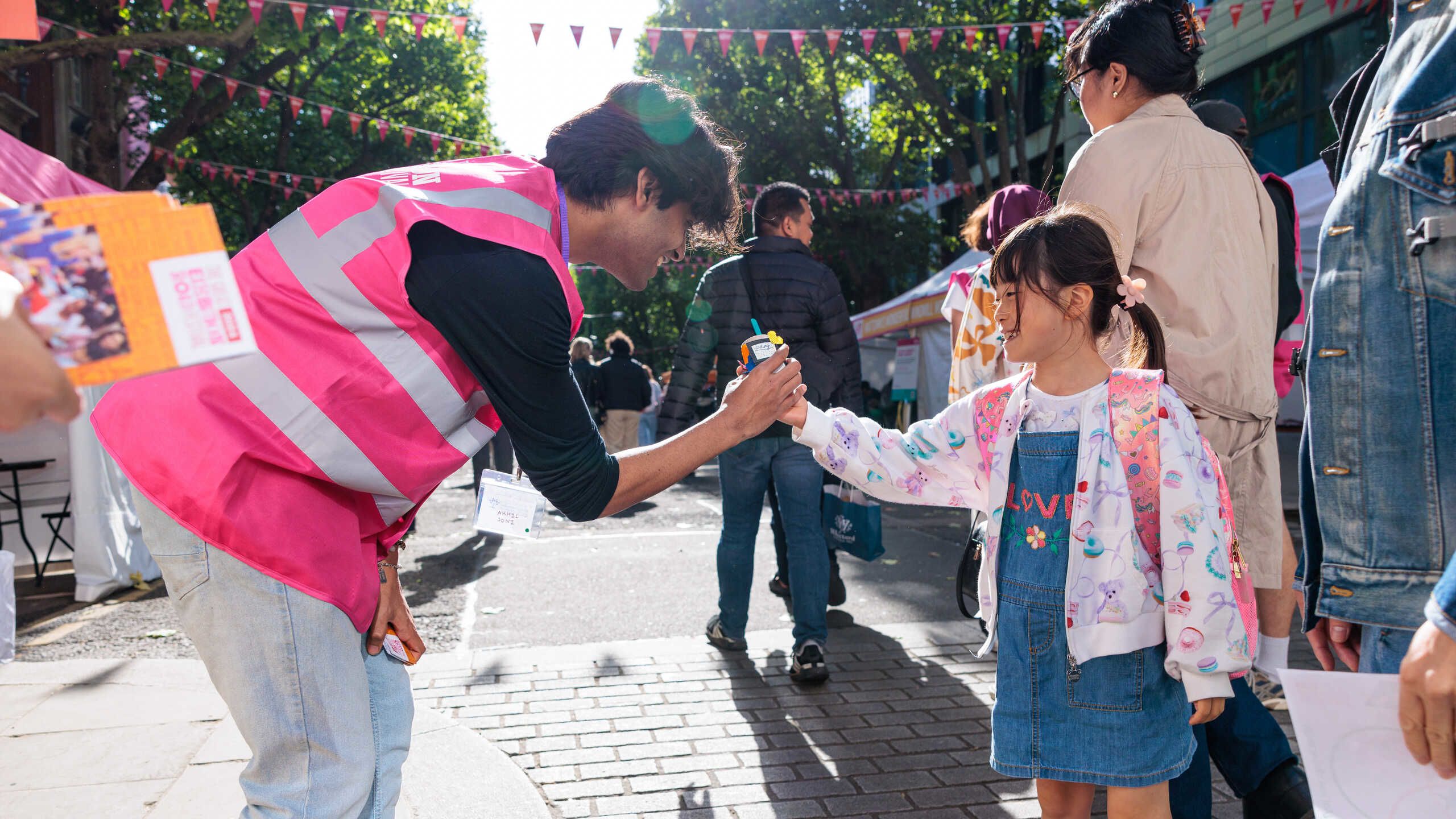 A volunteer chats with a child at the Great Exhibition Road Festival