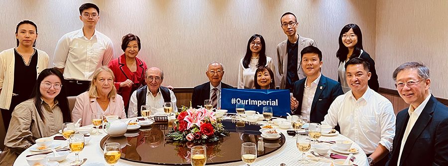 Members of the alumni group in Hong Kong seated around a table