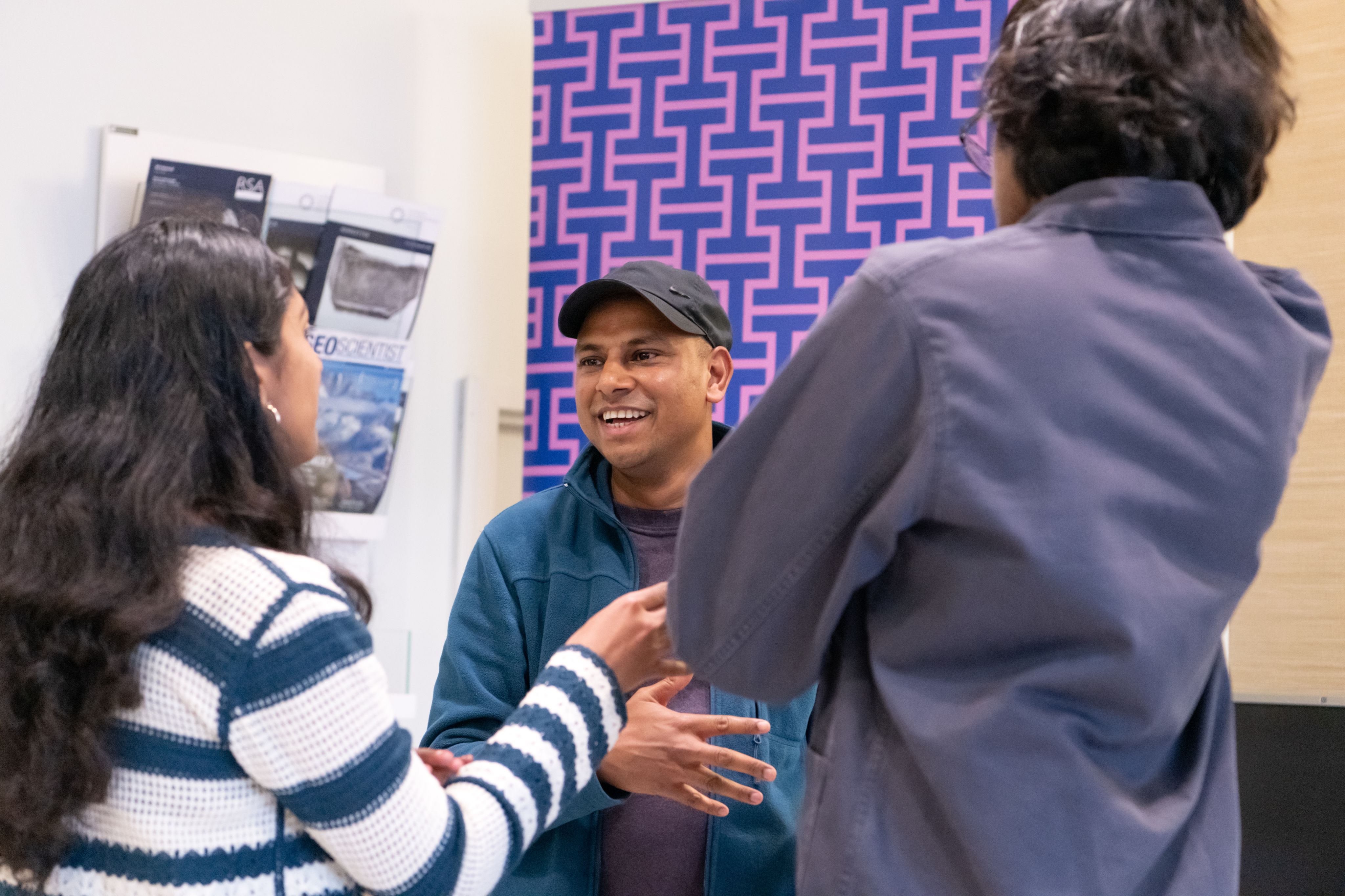 Alumni chat during a supporter drop-in at the Festival