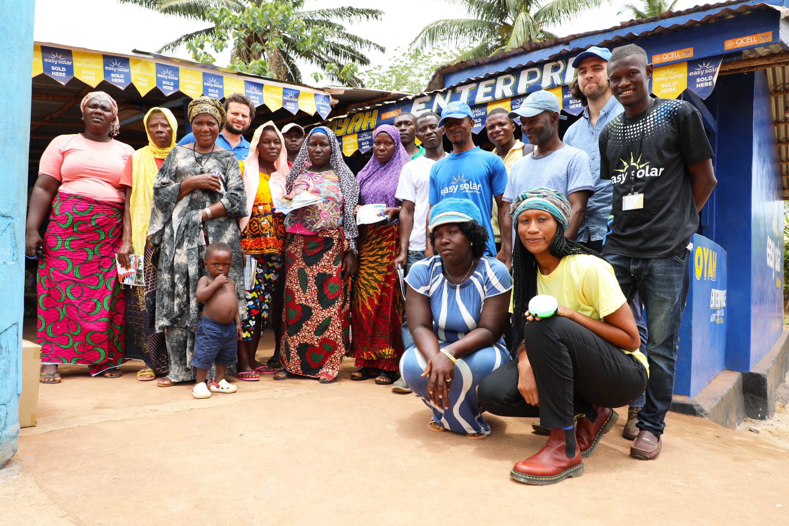 Alex and his colleagues at an Easy Solar office with members of the local community