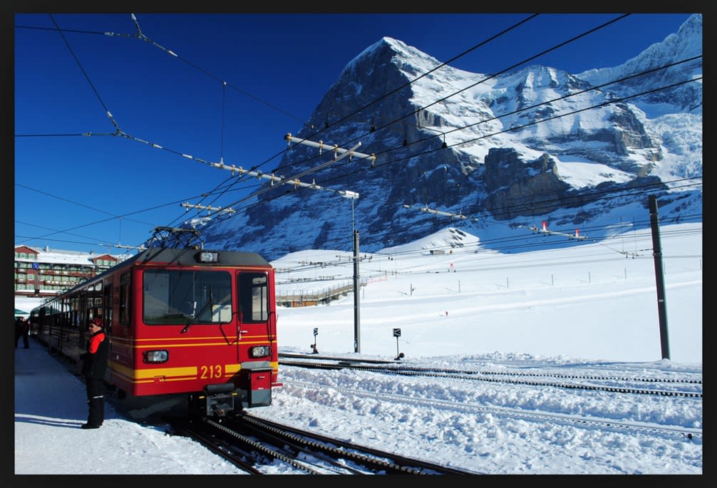 Train on the Jungfrau railway with snowy mountains in the background