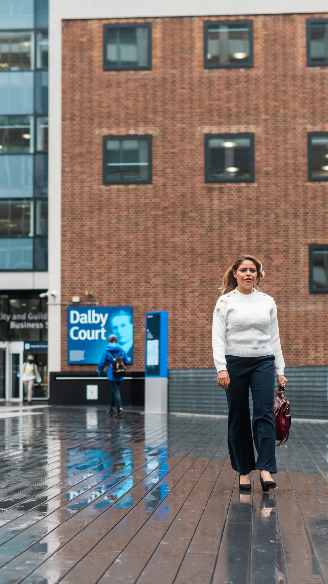 Dr Wareed Alenaini walking across Dalby Court at Imperial's South Kensington Campus