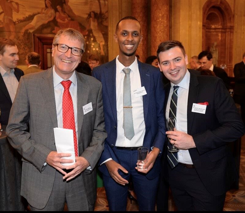 Abdirahman with two alumni of the Sainsbury Management Fellowship.