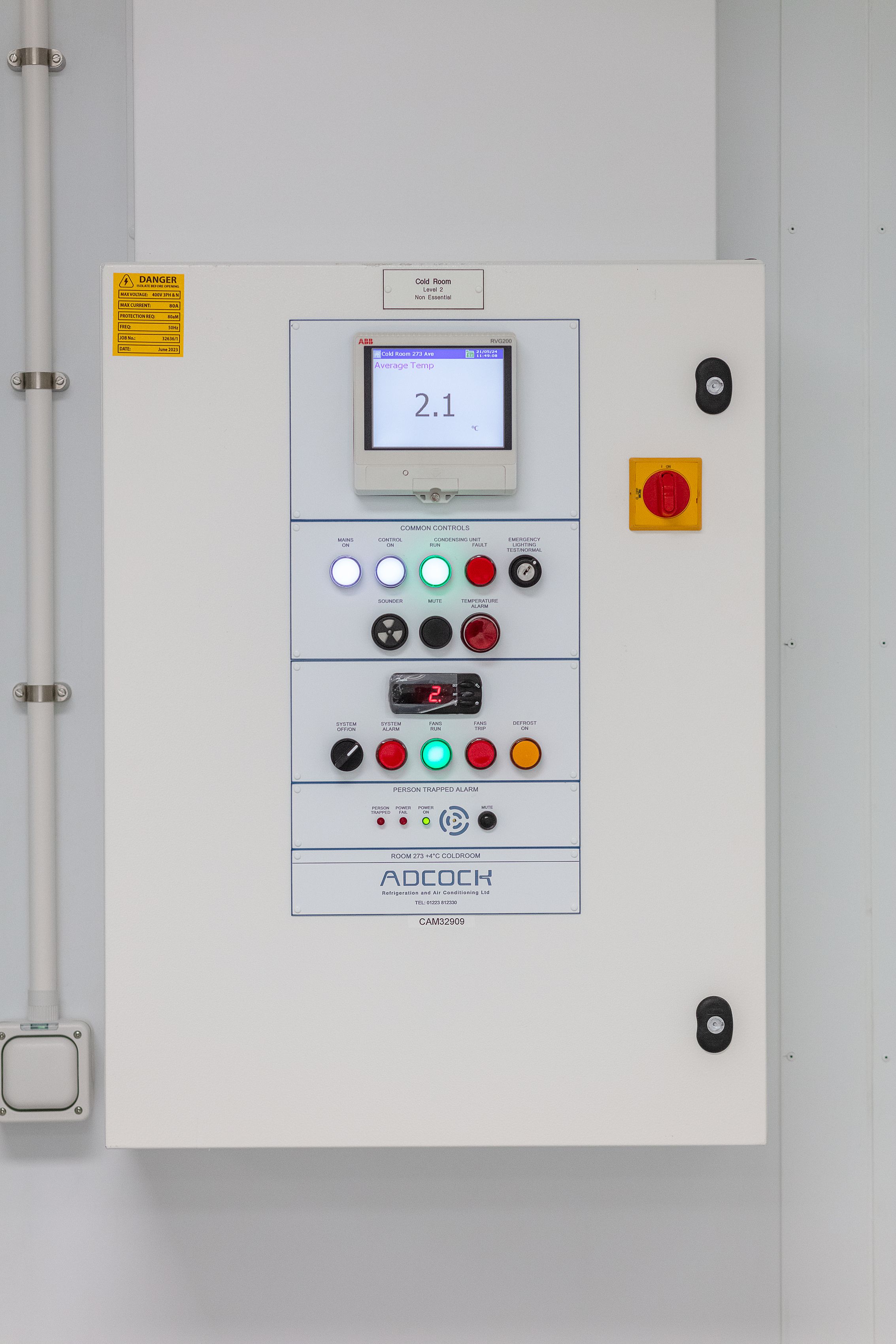 A rectangular control panel with lights and digital displays