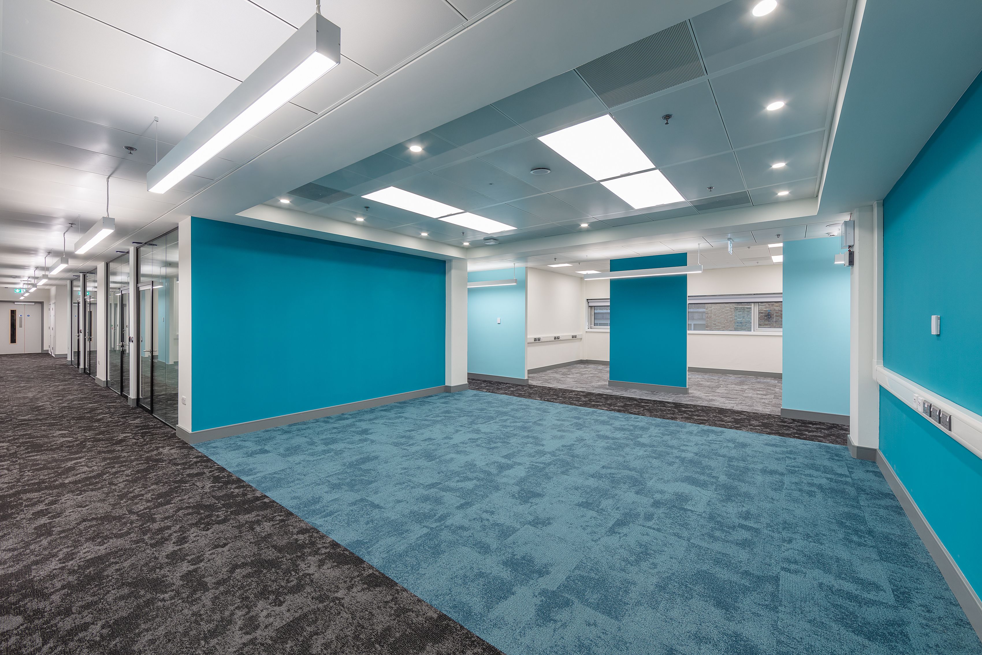 One of the shared collobrative break-out spaces, ready for furniture to arrive, with the chosen new Imperial branding colour, including Teal