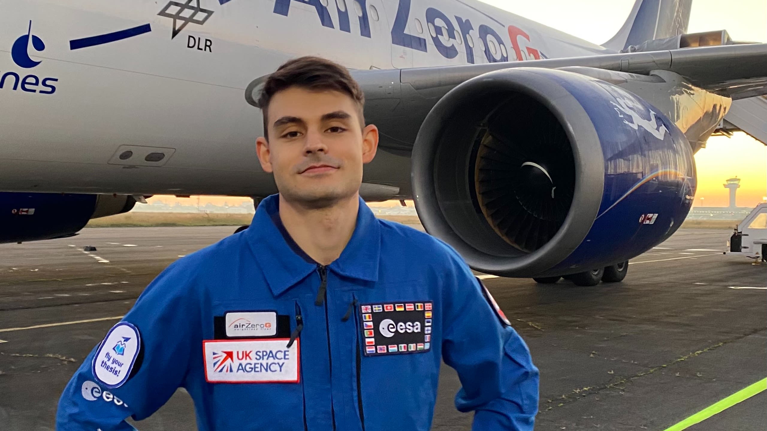 Jesús standing in an airfield next to a parabolic flight plane