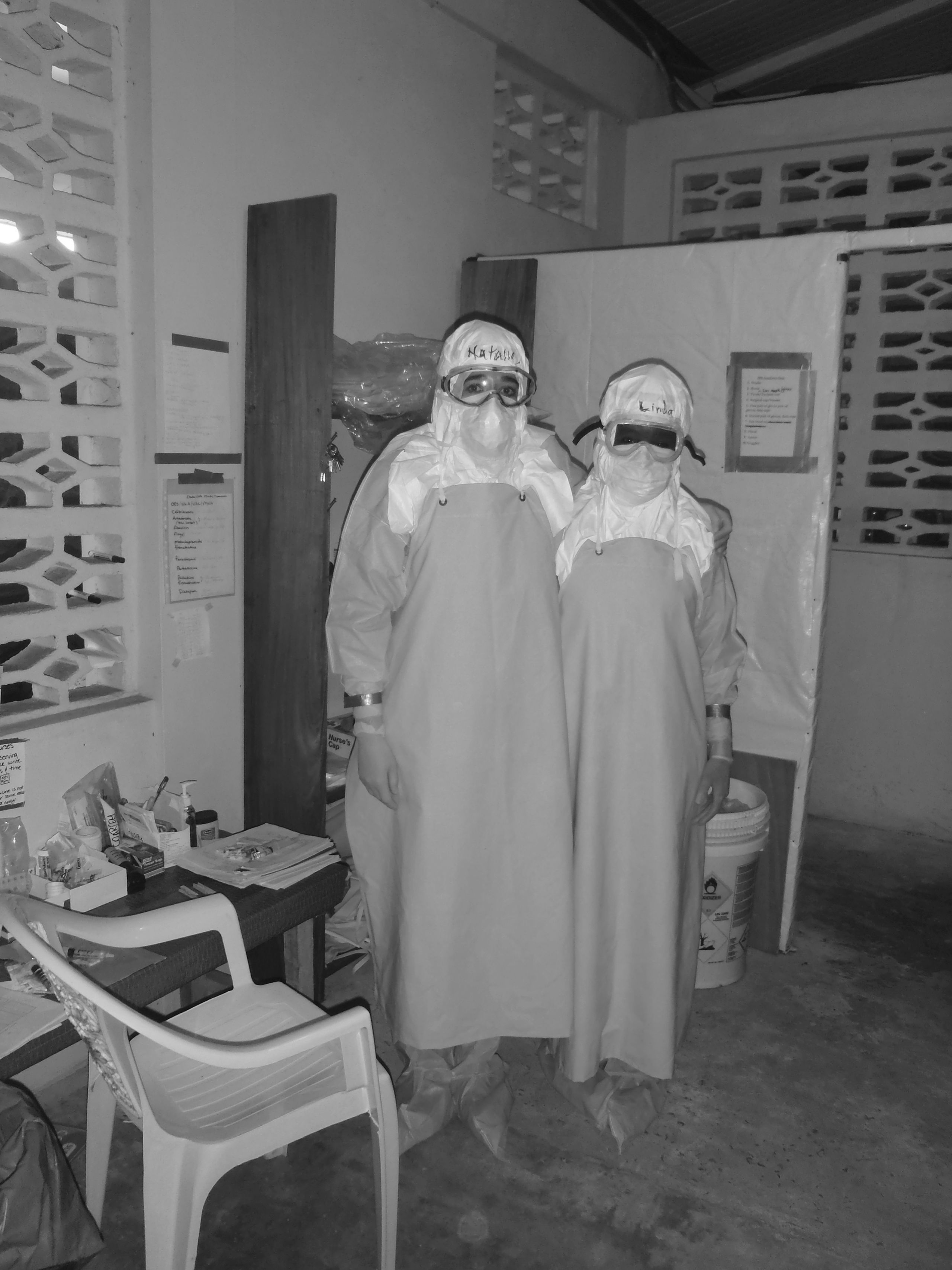 Two medical professionals in protective clothing at an Ebola treatment centre