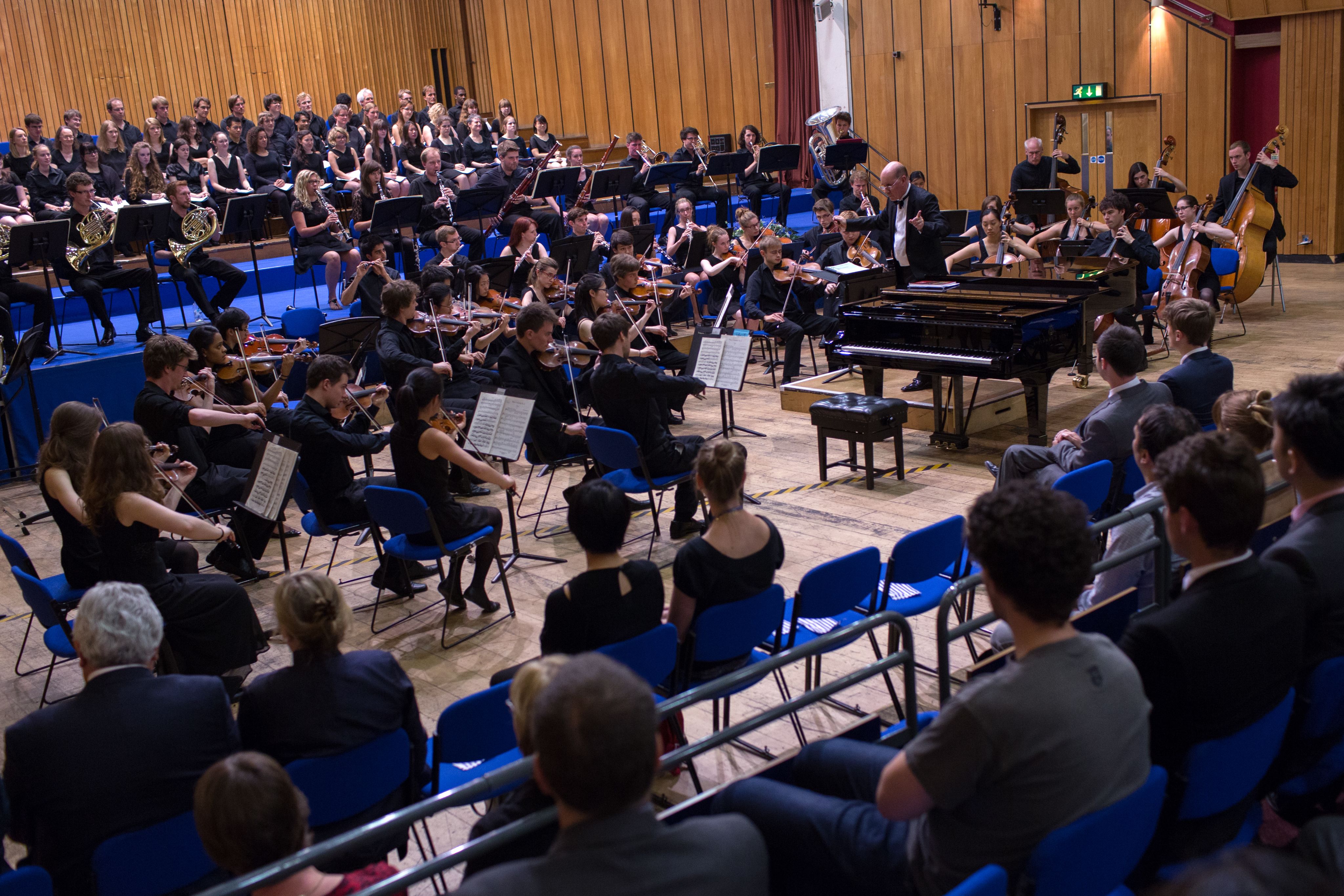 A photograph of the orchestra playing a concert in the Great Hall in 2014.