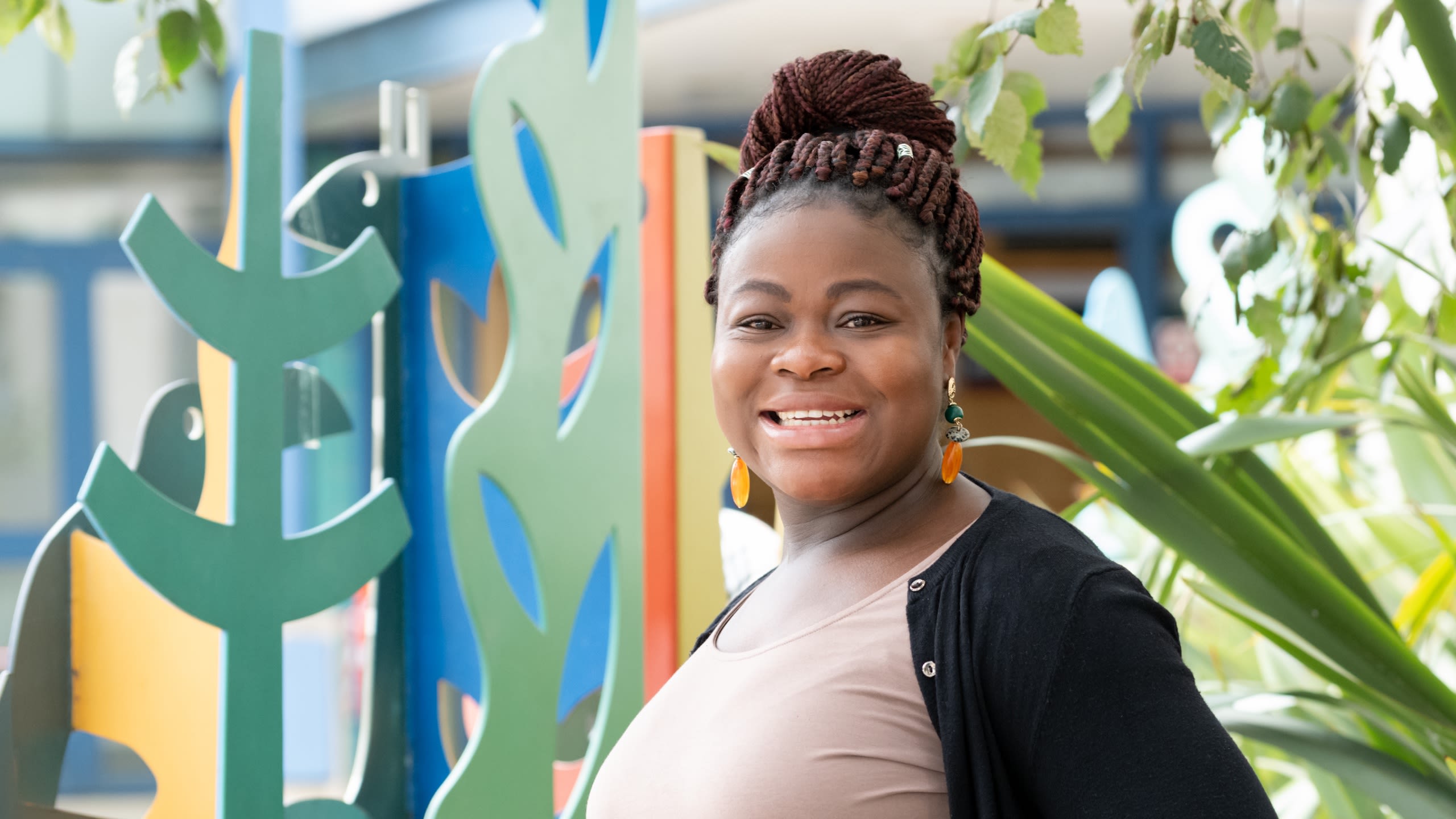 Theresa Akasi smiling outside Queen Charlotte's and Chelsea Hospital