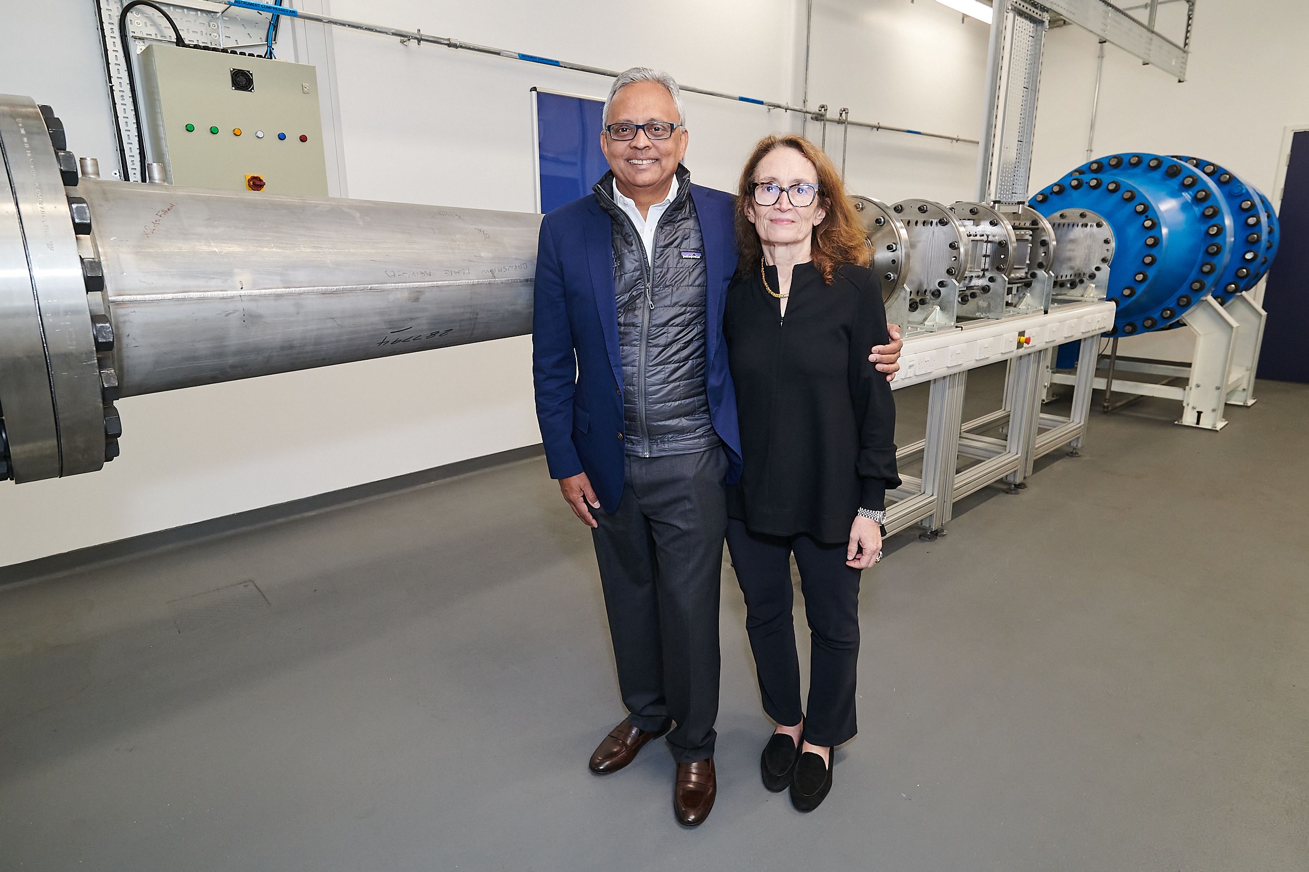 Donors Sanjay and Leslie Patel standing in front of the supersonic wind tunnel 