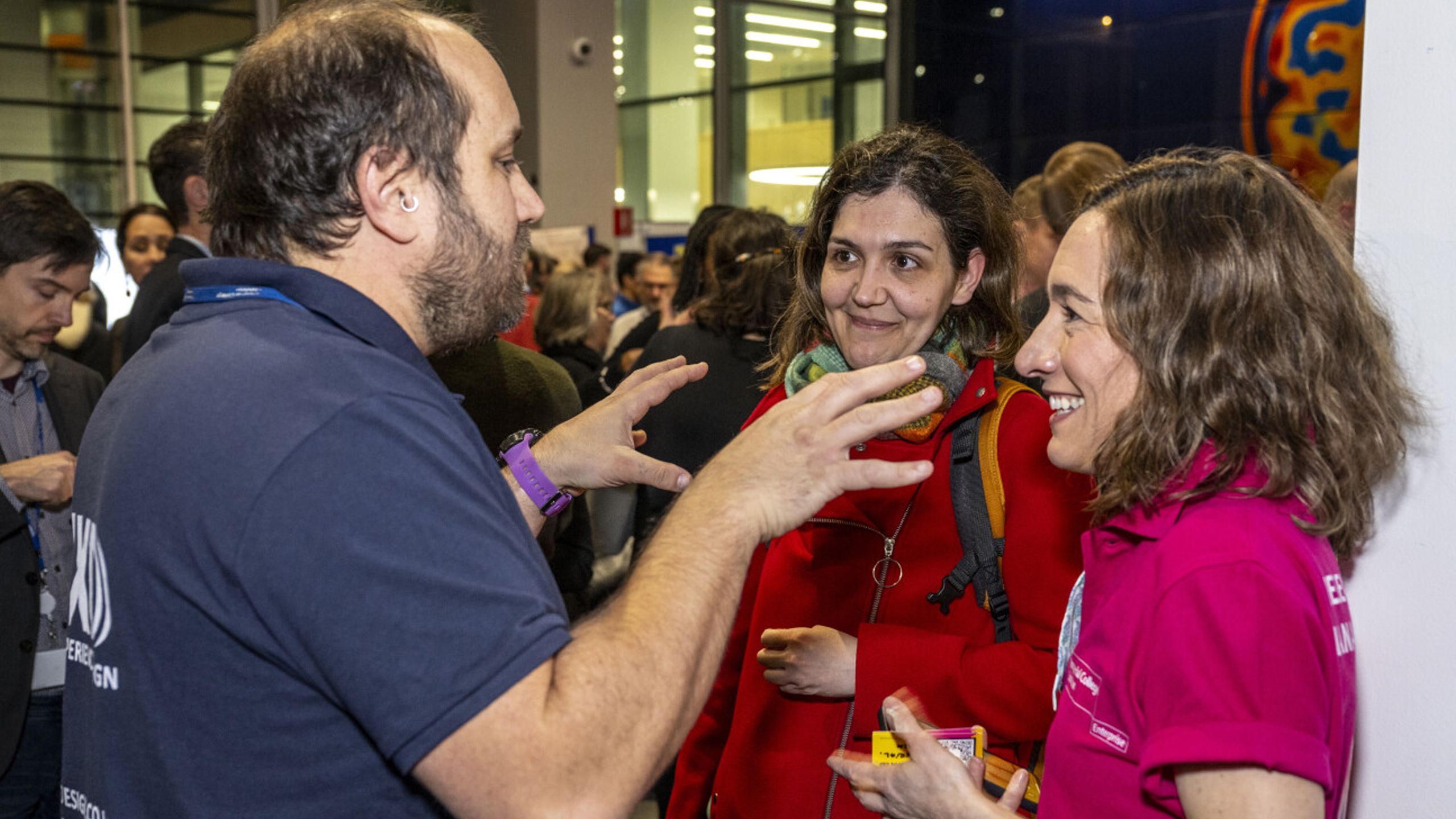 three people talking at a science fair