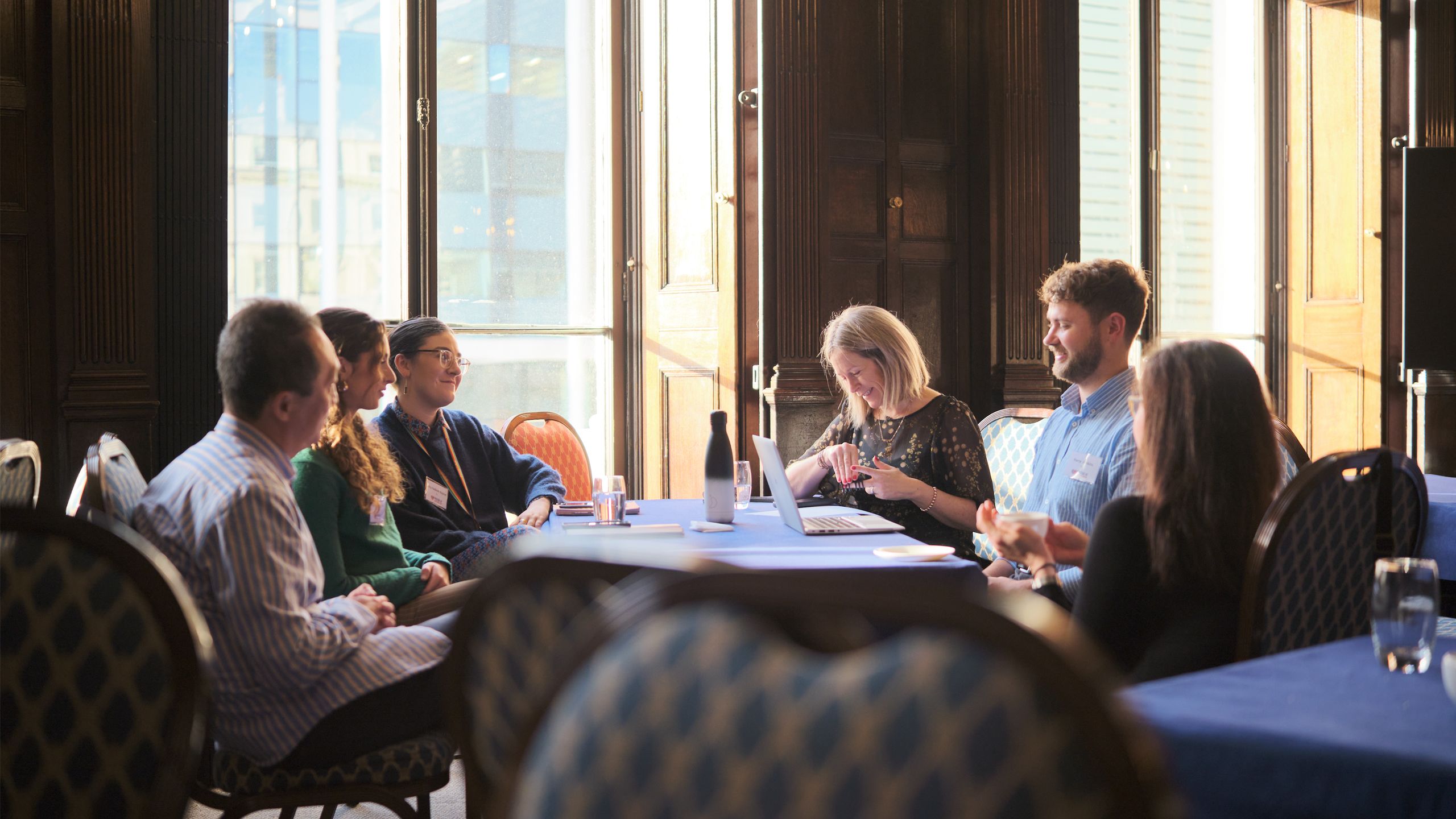 business people sitting around a table talking