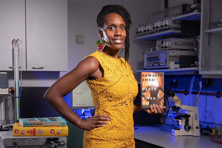 Simone holds book standing in lab