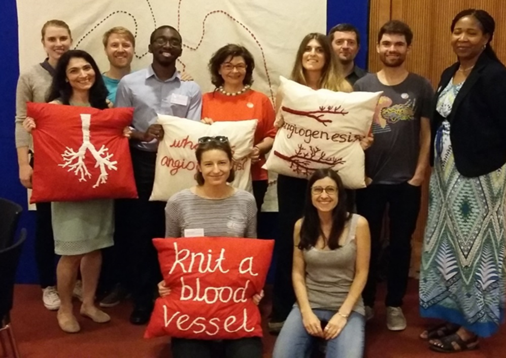 Researchers with embroidered cushions