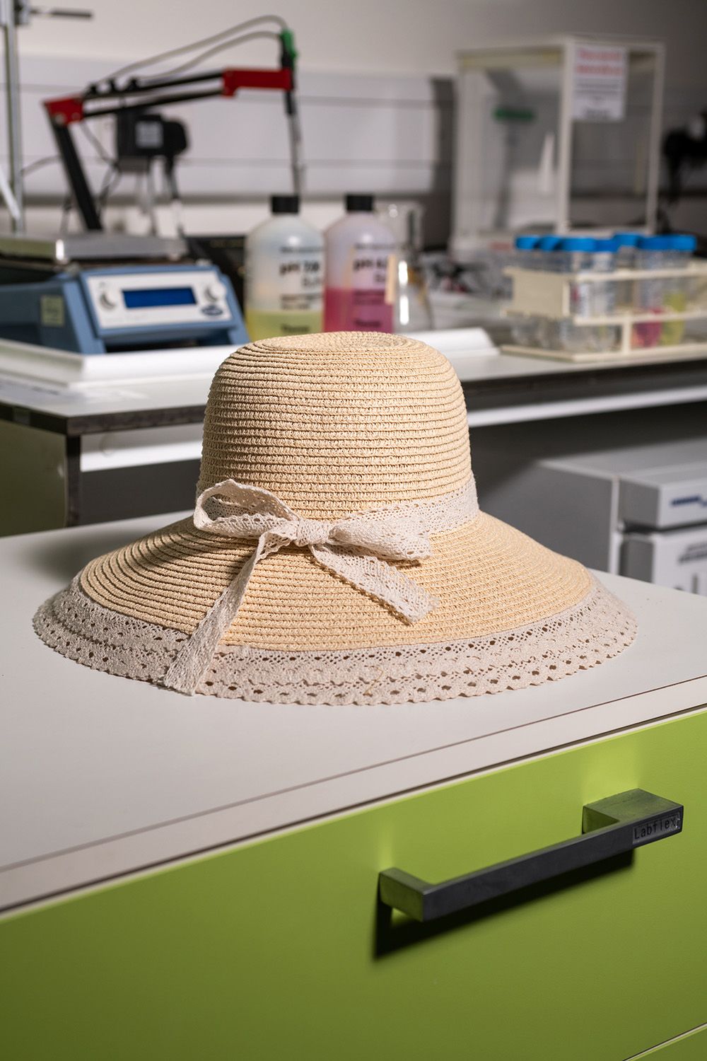Hat in front of lab equipment