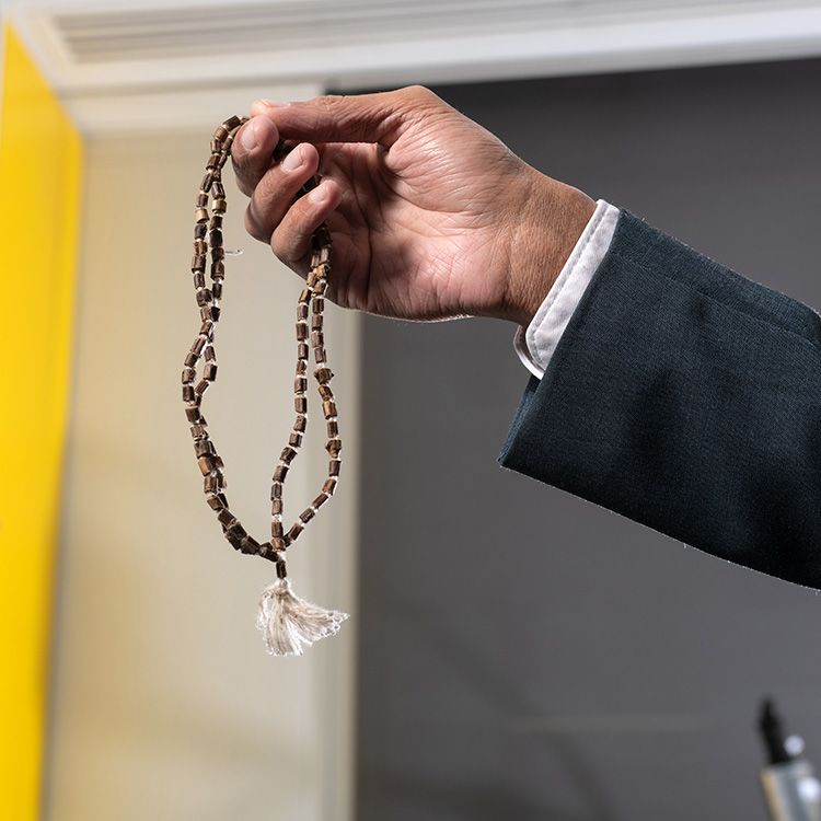 Prayer beads clasped in a hand